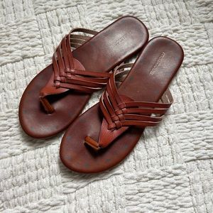 woman’s tan backless sandals